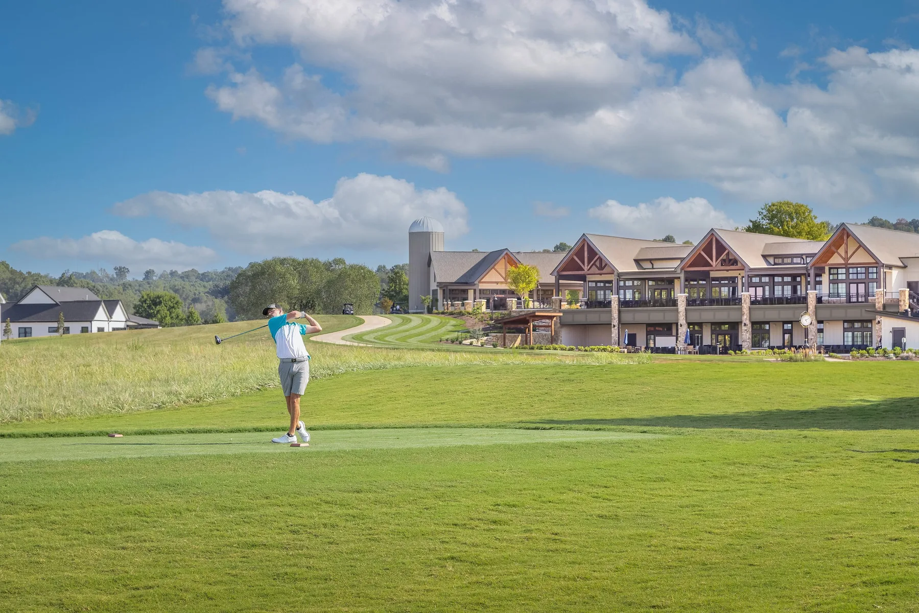 Tennessee National clubhouse exterior with golfers
